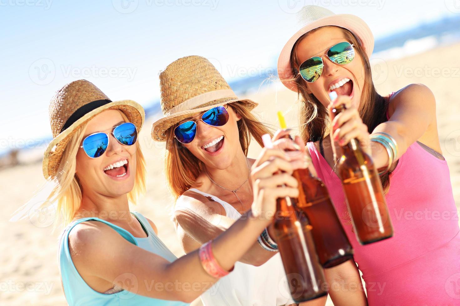 Girl friends on picnic on the beach photo