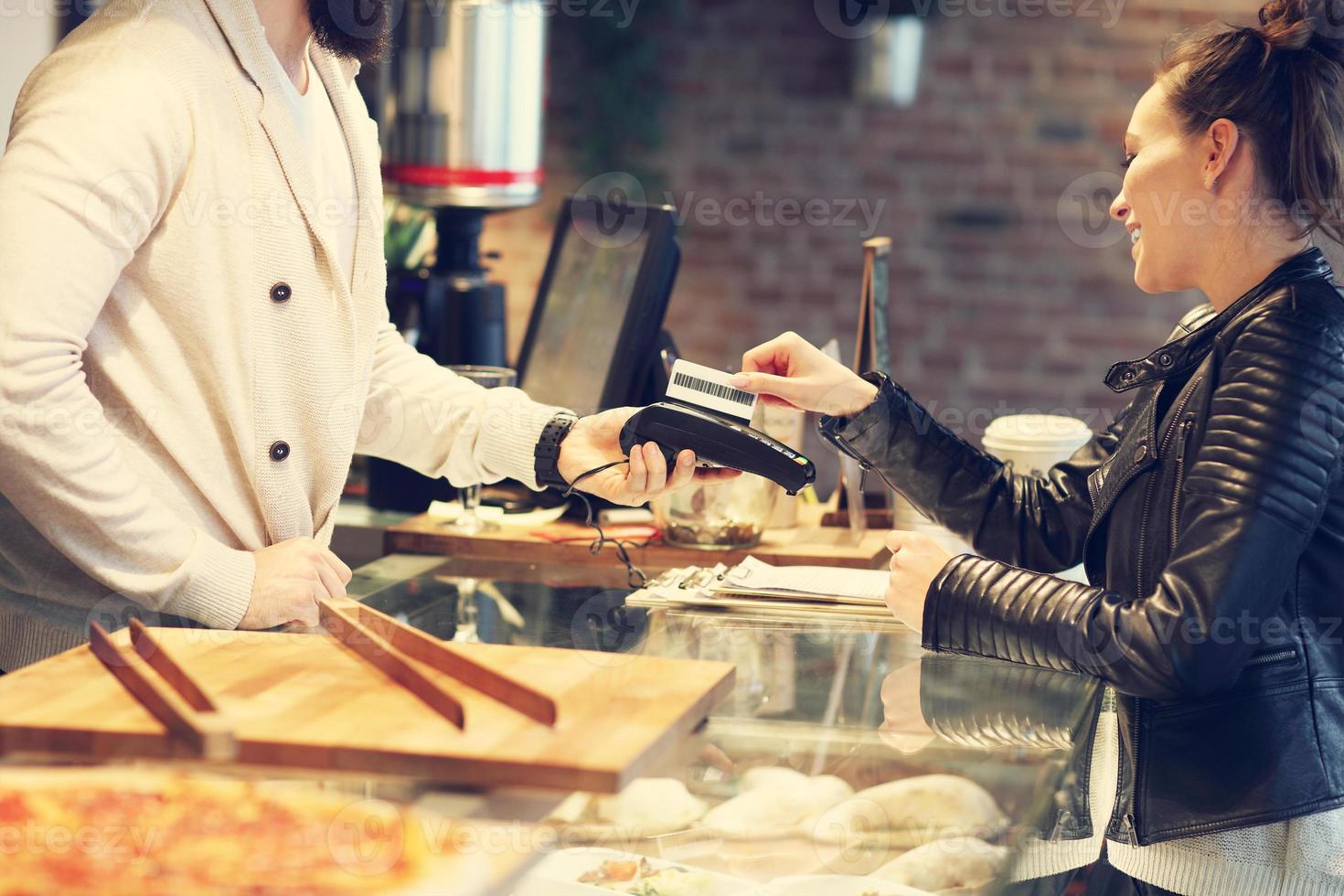 Woman paying in restaurant photo
