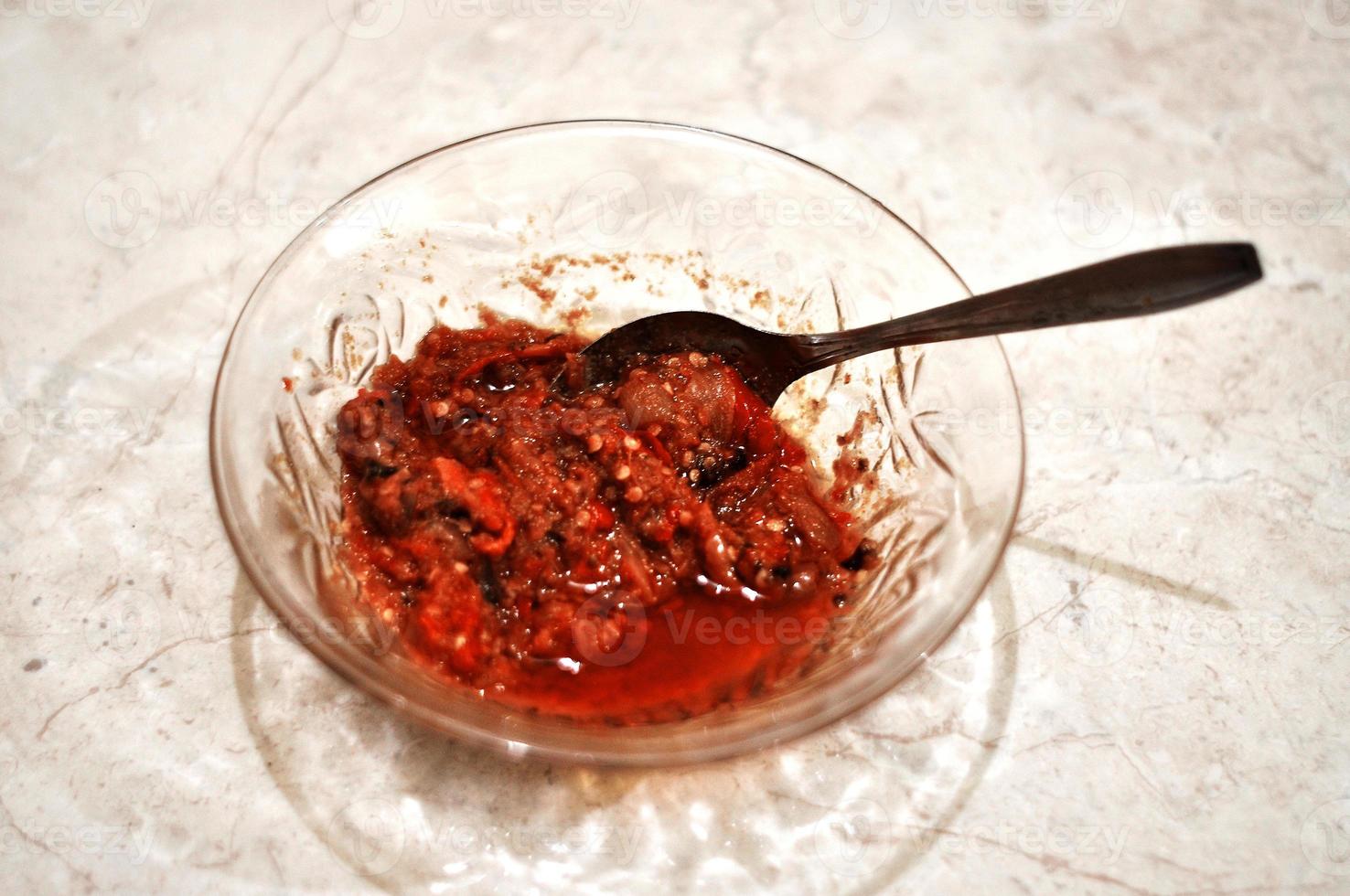 delicious spicy sambal food and spoon in bowl photo