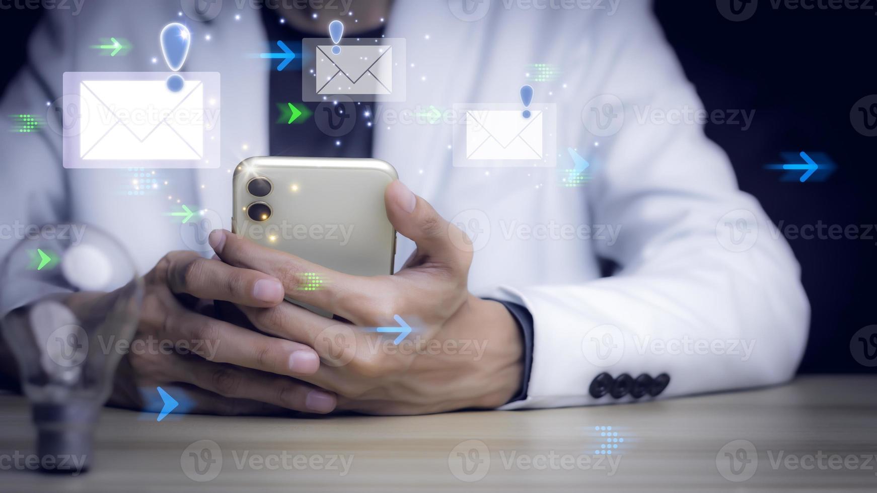 Businessman touching smartphone with open e-mail, receiving business e-mail news alerts Advertising by sending and customer messaging. online digital technology direct selling business, reminder. photo