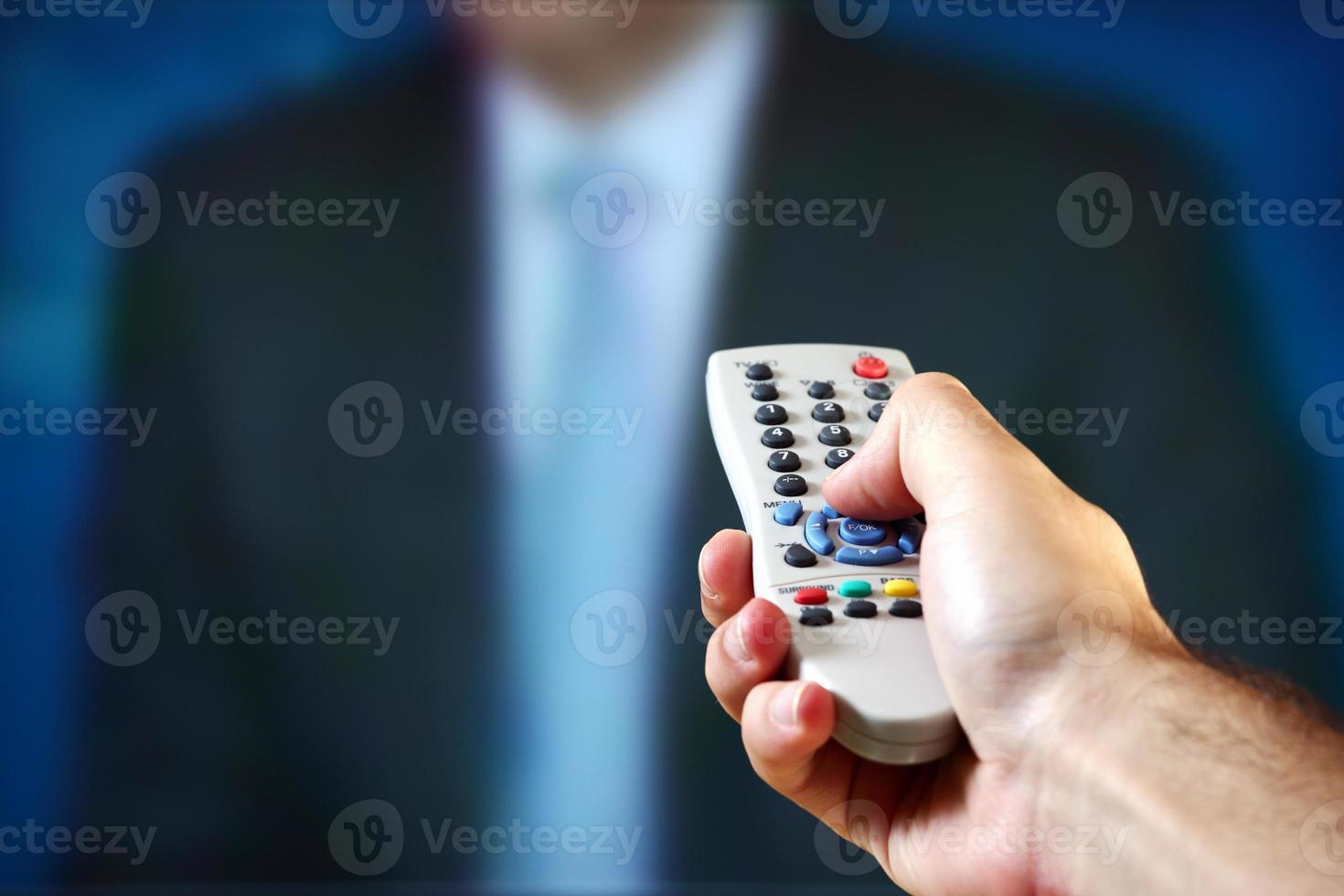 Male hand holding a remote control photo