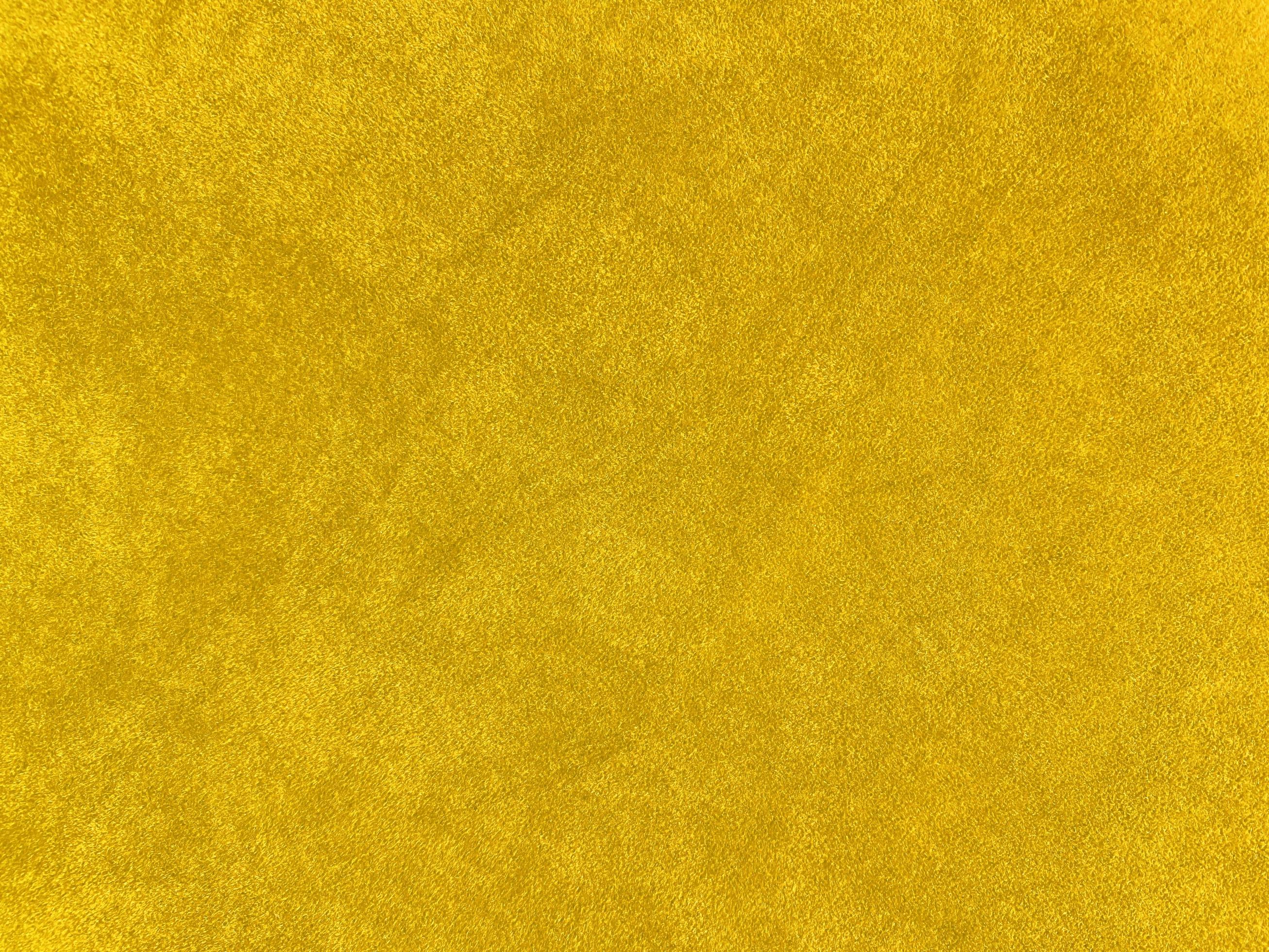 Yellow velvet fabric texture used as background. Empty yellow fabric