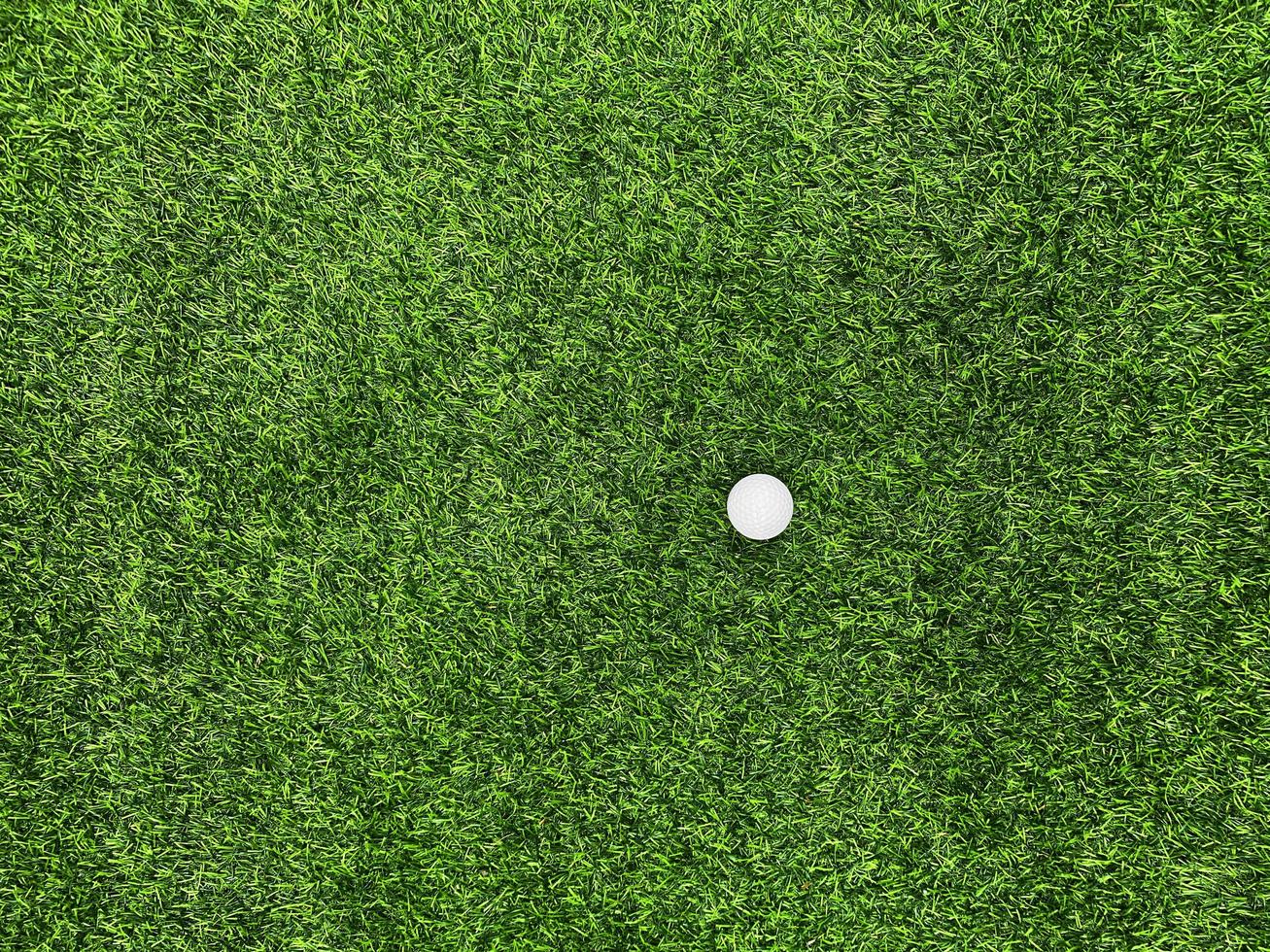 Golf ball close up on green grass on blurred beautiful landscape of golf  background.Concept international sport that rely on precision skills for health relaxation. photo