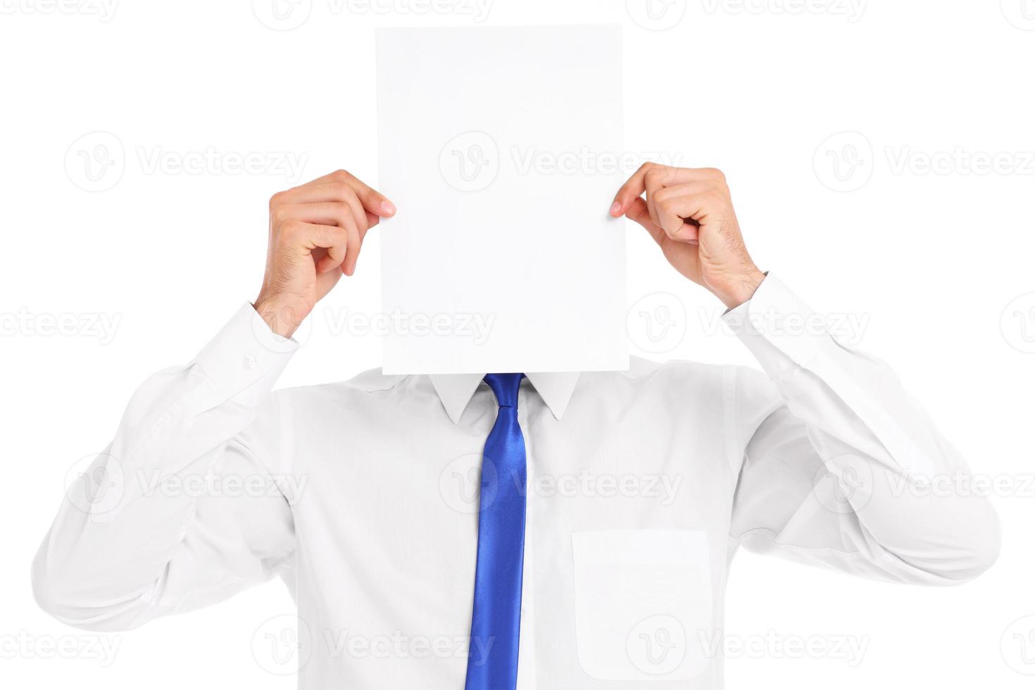 Businessman covering his face with a paper photo