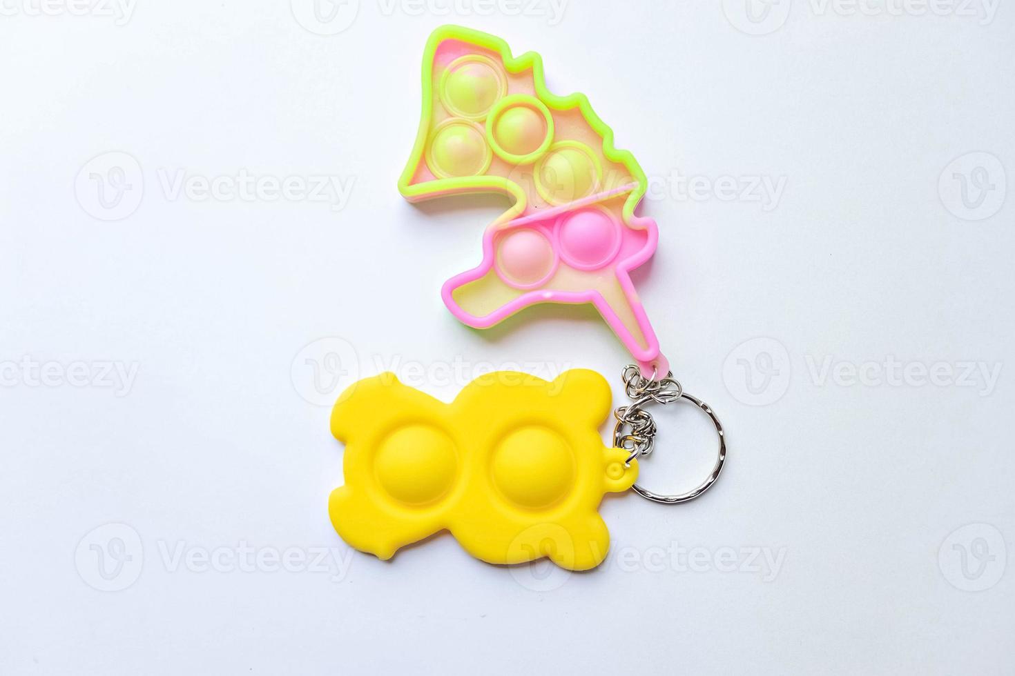 Pop it fidget toy. Multi-colored anti-stress toy with a wing shape on a white background photo