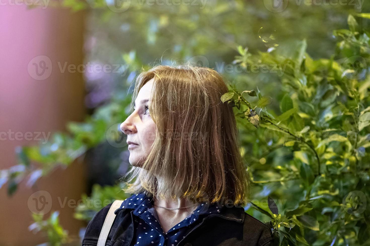 Portrait of a young woman in a night city on a summer evening. City lights photo