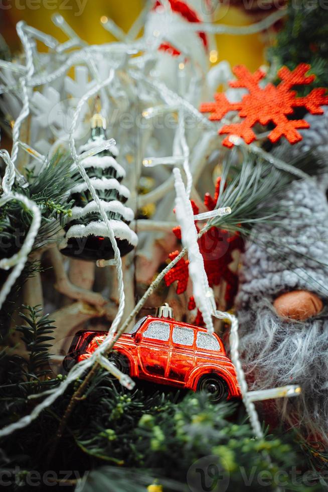 Red car, snowflake and Christmas tree on pine braches photo