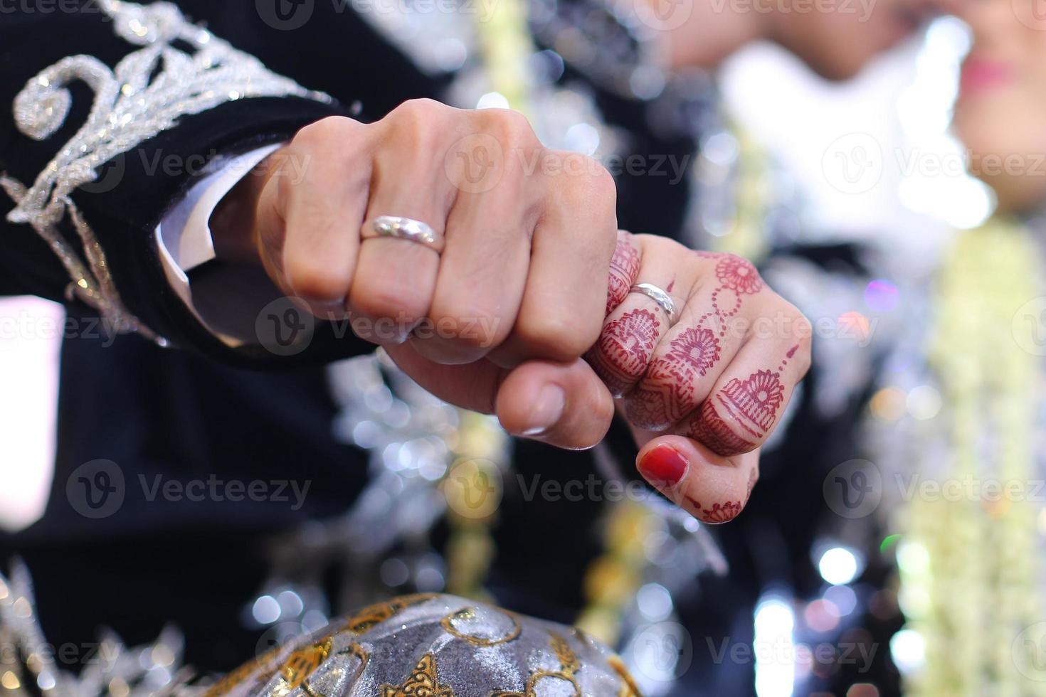 henna tattoo being applied on a women's hand. photo