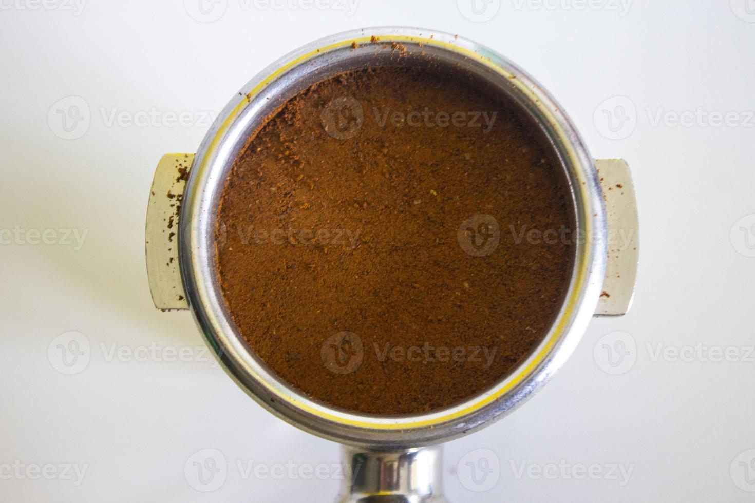 porta filter with ground coffee and coffee bean isolated from a white background photo