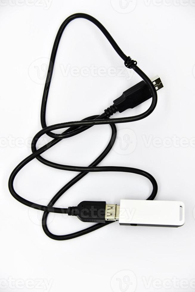 Router on a black cable on a white background. A white USB flash drive on the cable. Wi-Fi router close-up. photo