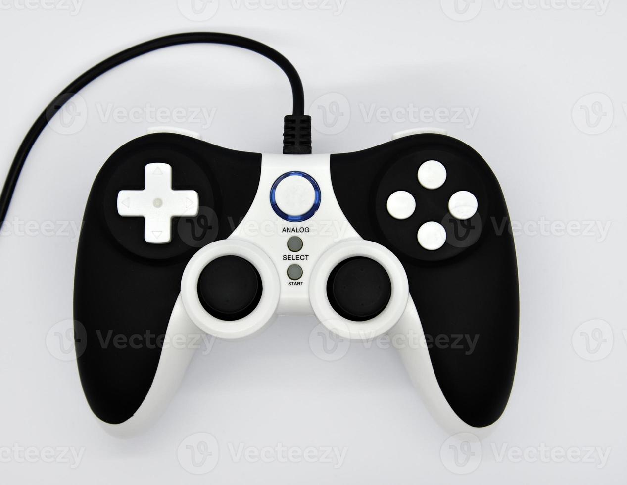 The gamepad is black and white on a white background. Game joystick close-up. A gamepad for a game console. photo