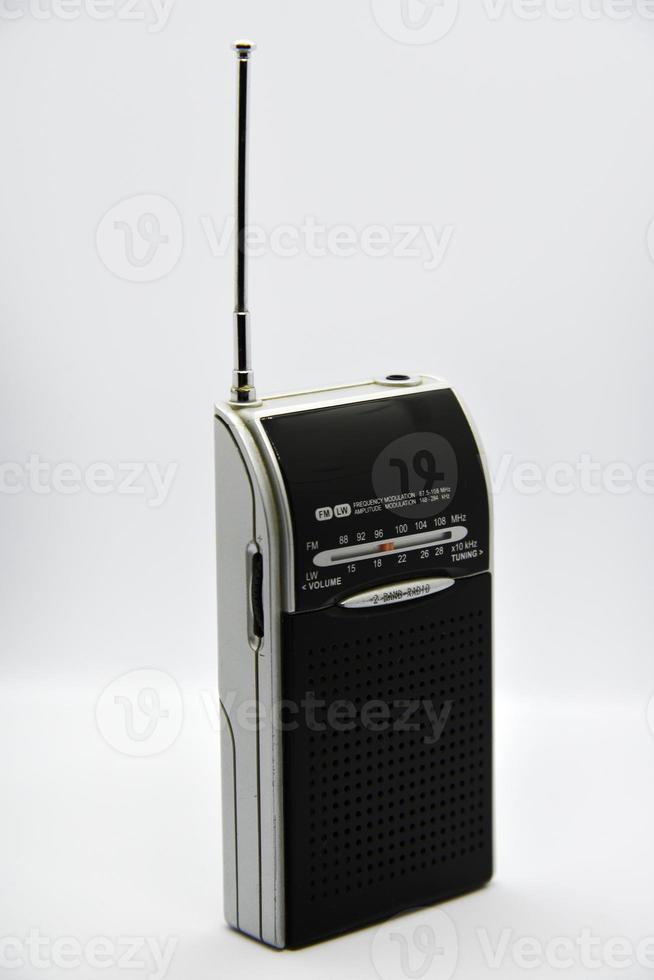 Portable radio receiver on a white background. Small player close-up. A battery-powered radio. photo