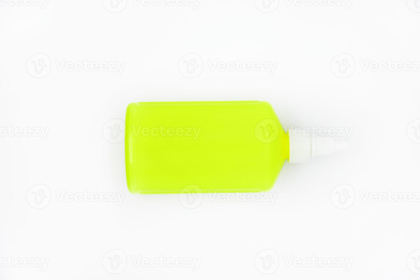 A bright green bottle of glue on a white background. Beautiful tube close-up. Green plastic bottle. photo