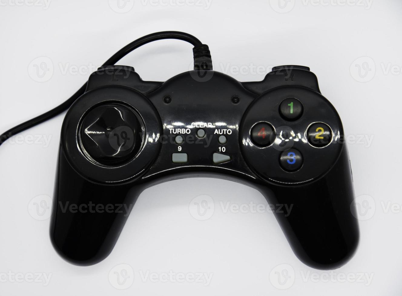 The gamepad is black and shiny on a white background. Game joystick close-up. A gamepad for a game console. photo