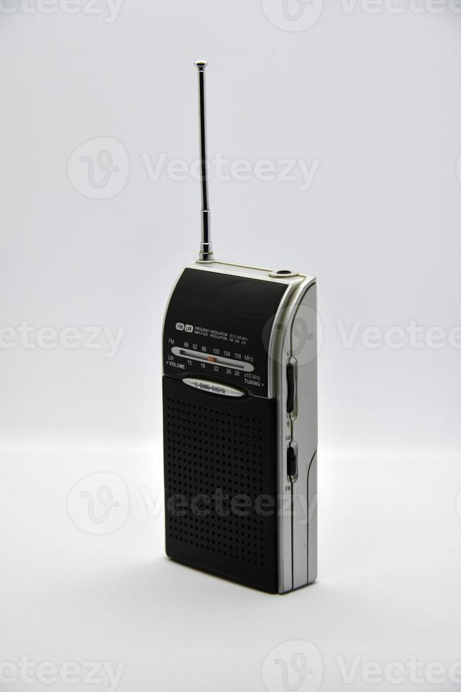 Portable radio receiver on a white background. Small player close-up. A battery-powered radio. photo