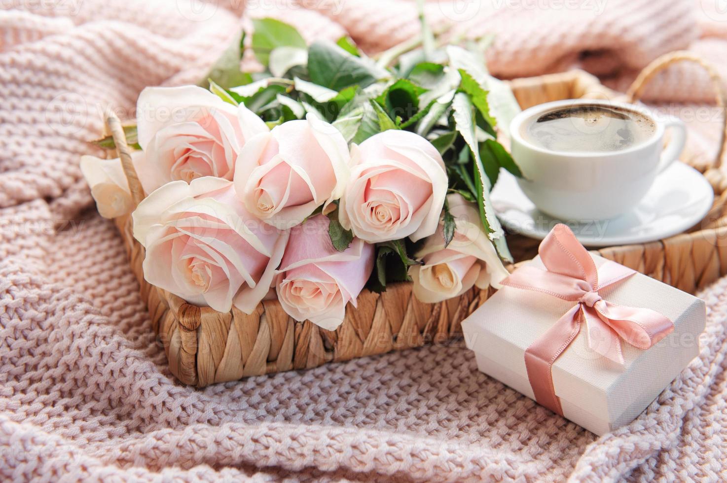 Tray with  bouquet of beautiful pink roses and gift box on  bed. photo