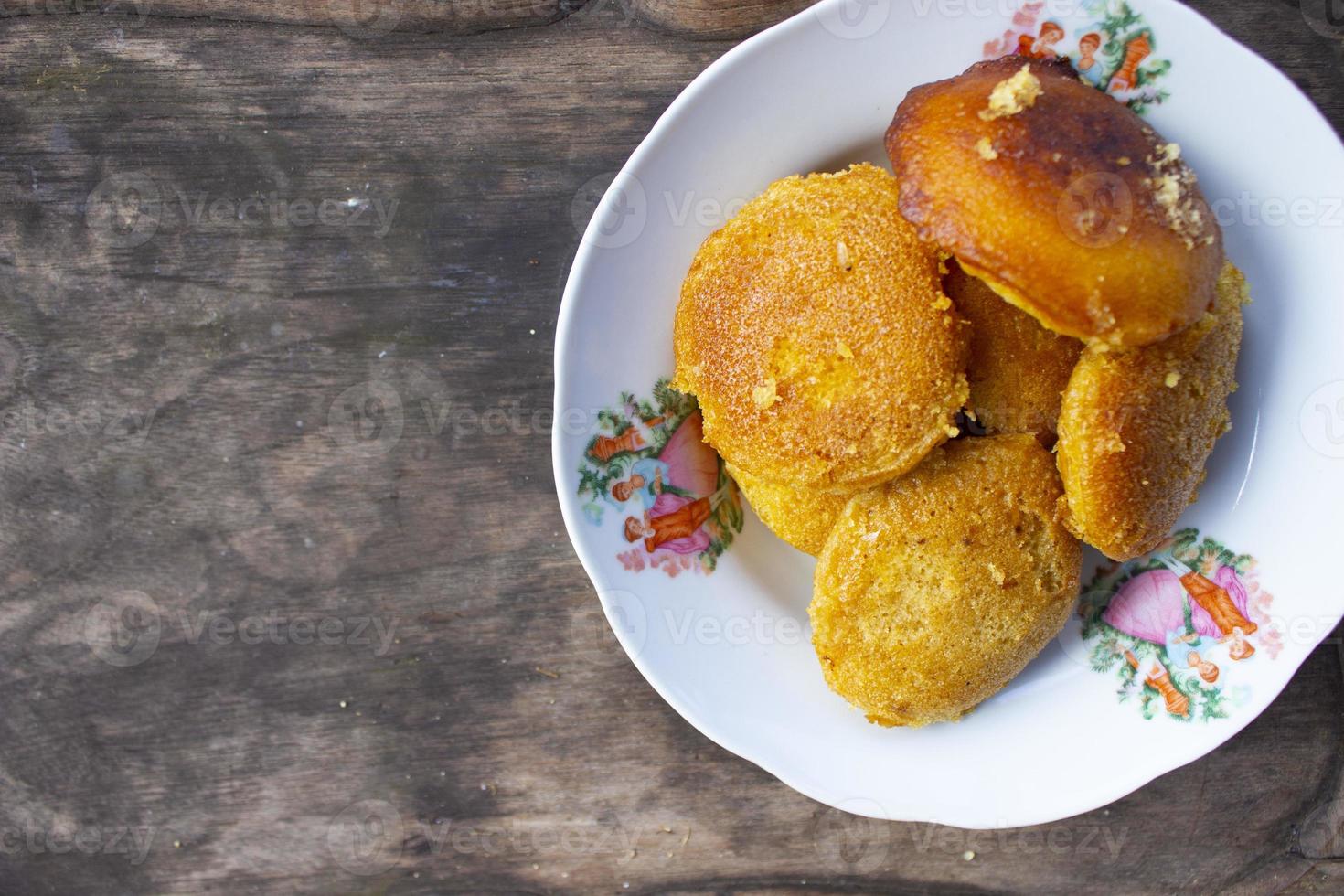 apem, or appam, is tradional snack food from indonesia. made from rice flour, eggs, coconut milk, sugar and tape and a little salt and then burned or steamed photo