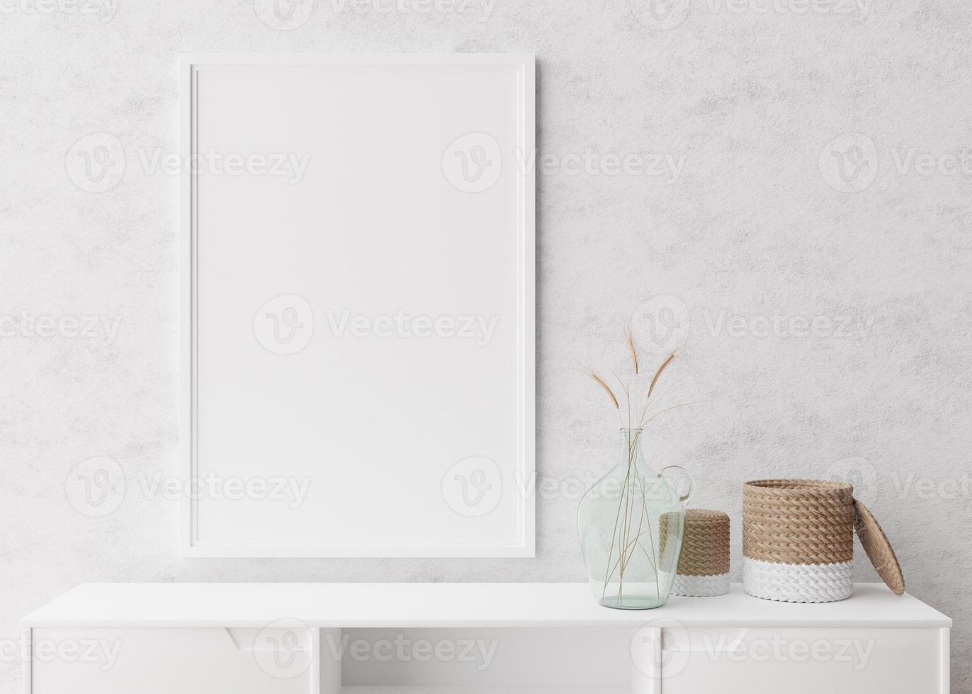 Empty vertical picture frame on white wall in modern living room. Mock up interior in minimalist, scandinavian style. Free space for picture. Console, rattan basket, dried grass in vase. 3D rendering. photo