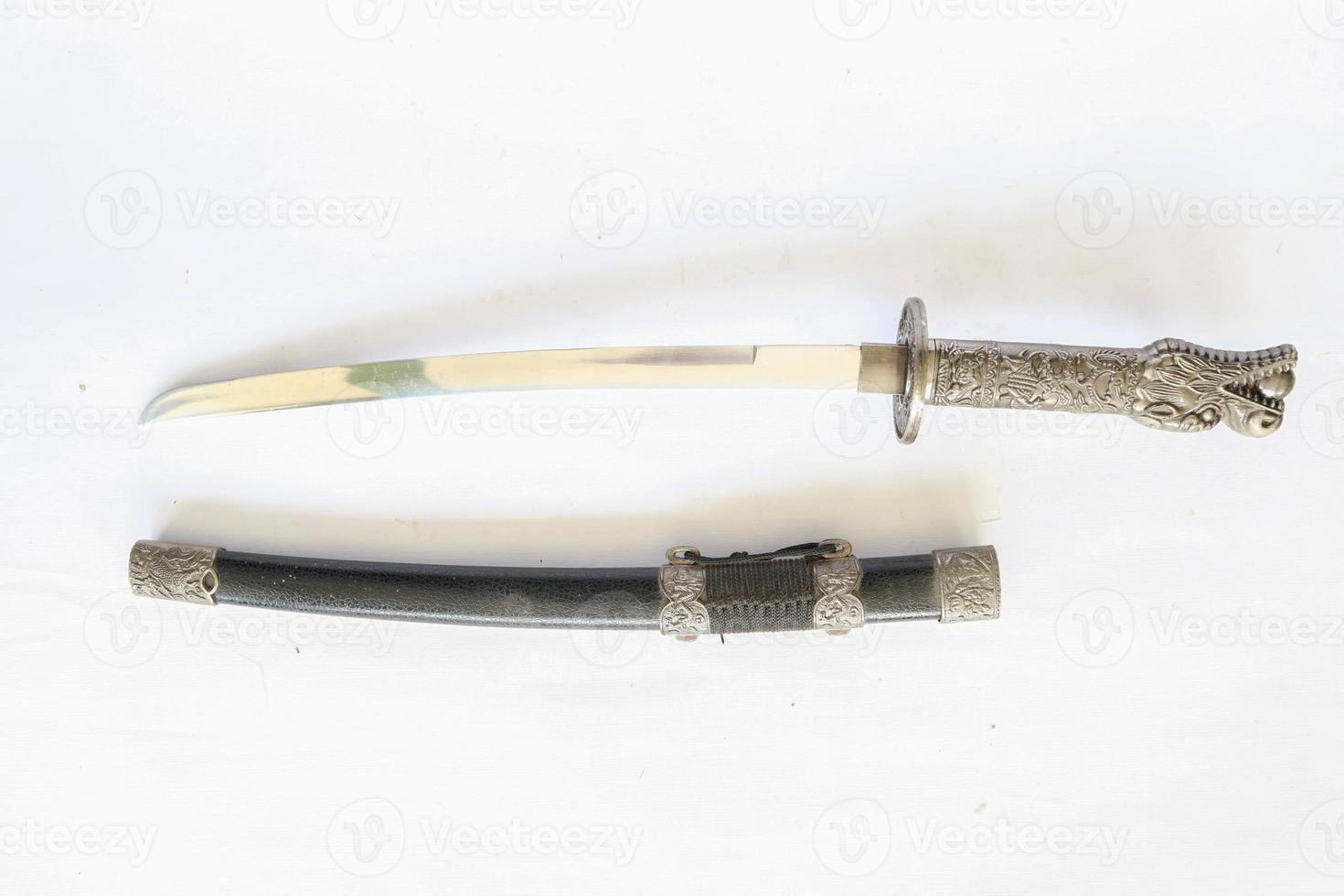 Japanese samurai short sword wakizashi , with dragon ornament, isolated on white background photo