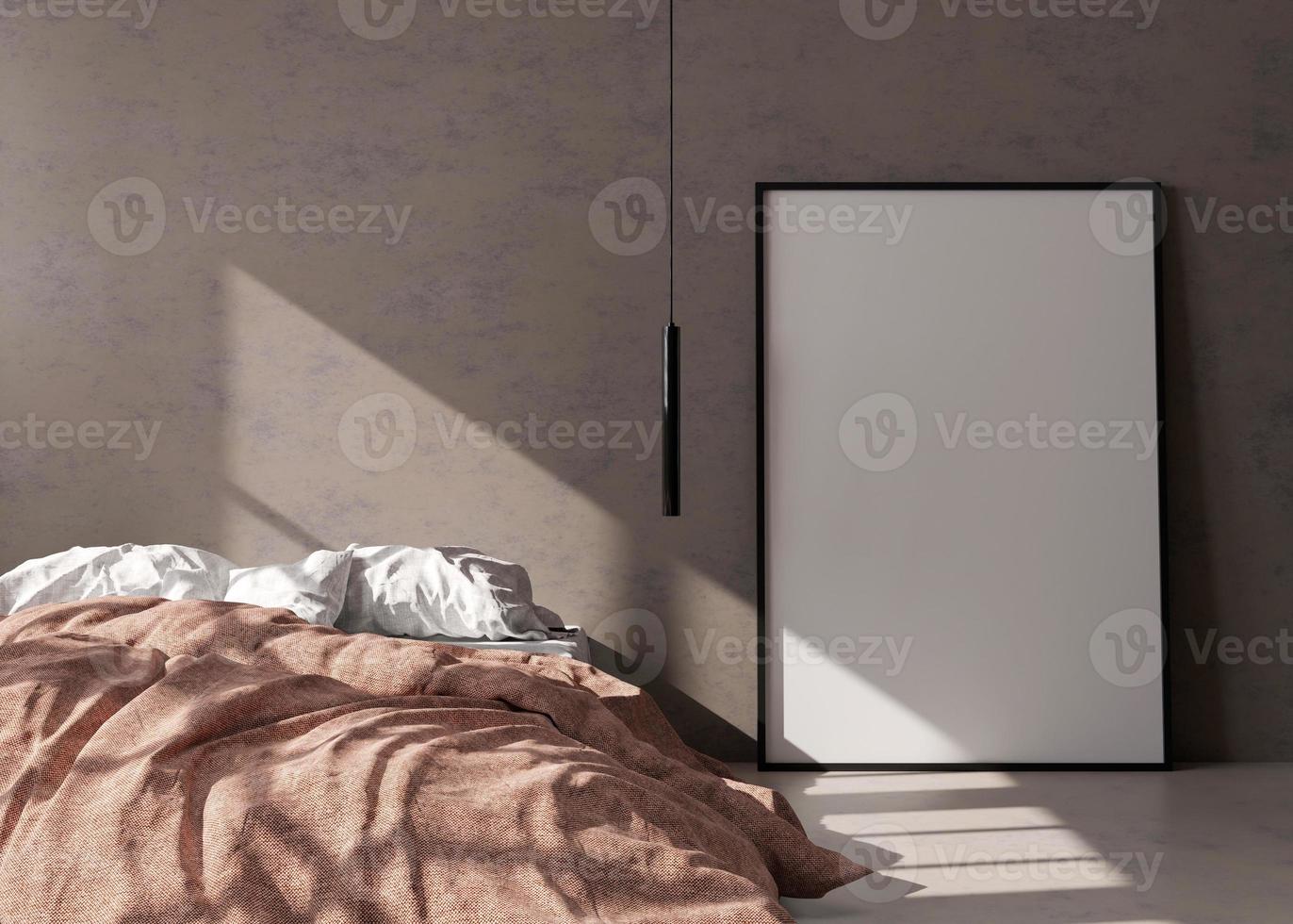 Empty vertical picture frame standing on concrete floor in modern bedroom. Mock up interior in minimalist, contemporary style. Free space for picture or poster. Bed, hanging lamp. 3D rendering. photo