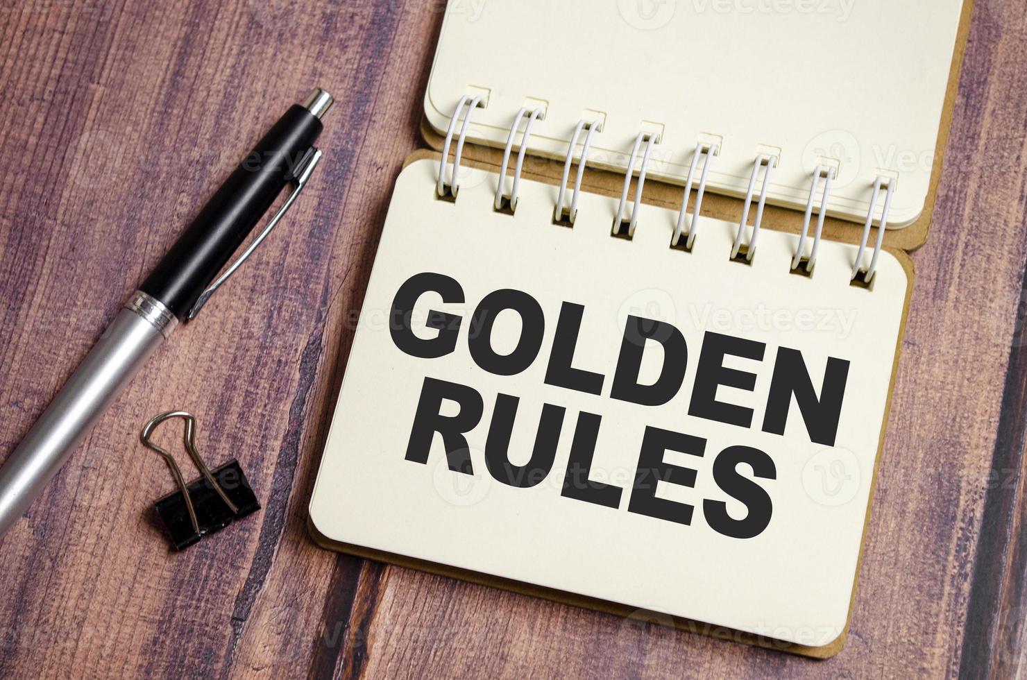 text GOLDEN RULES on notepad paper with pen photo