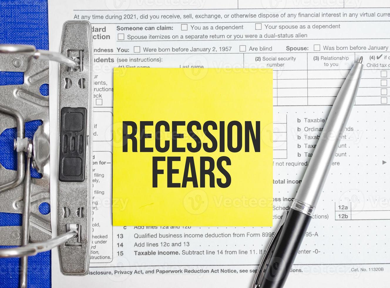 Recession fears words on paper notebook with pen photo
