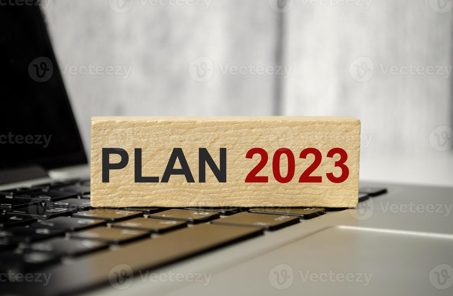 2023 Year block against computer laptop background. Goal, Target, Resolution, strategy, plan, finance, budget, motivation and new year start photo