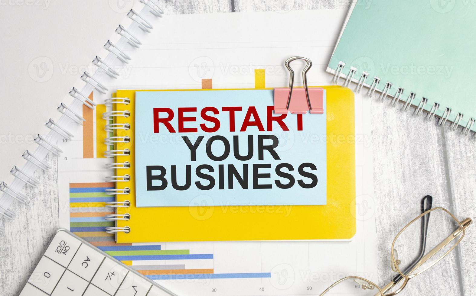 restart your business words on blue sticker with glasses photo