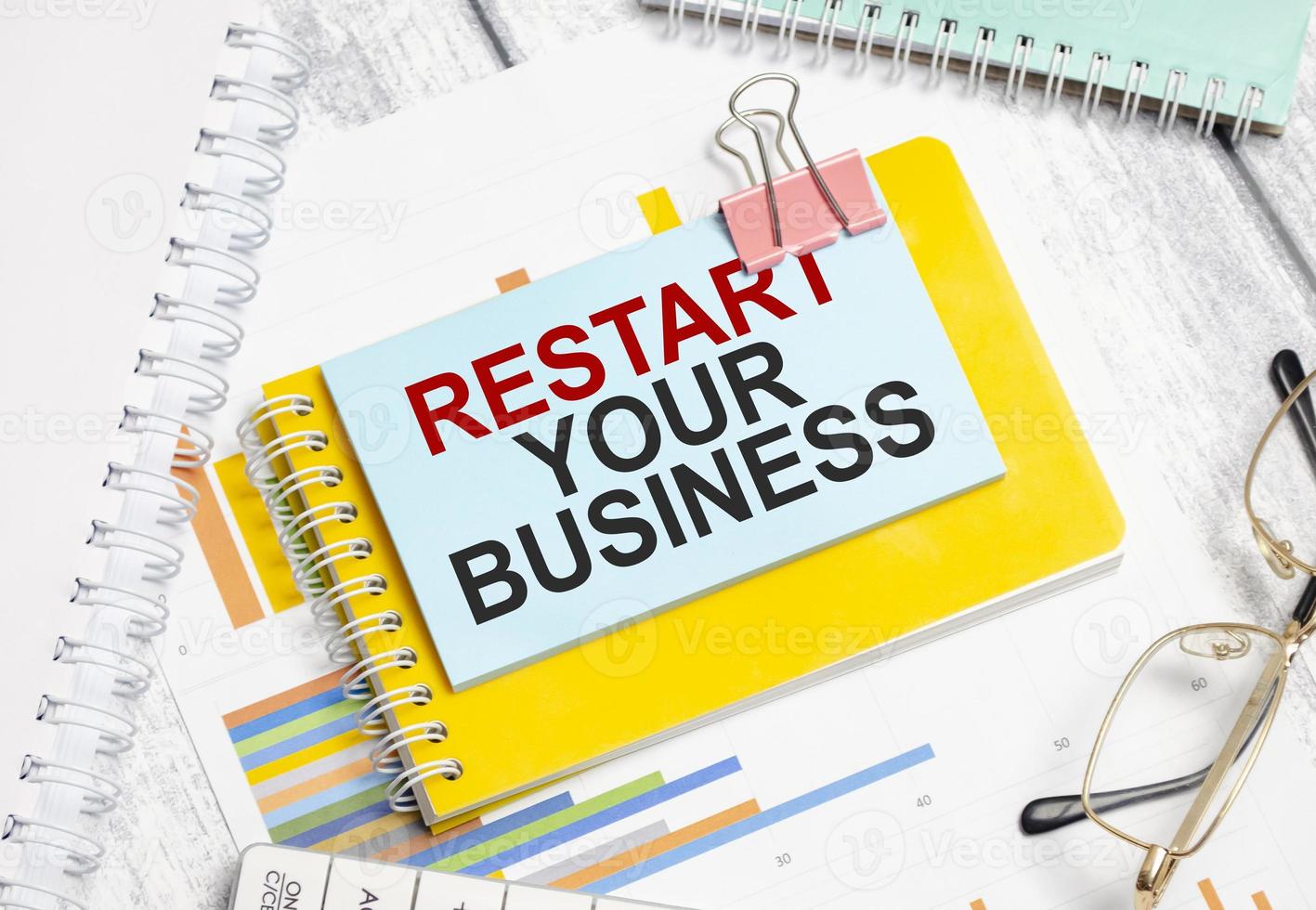 restart your business words on blue sticker with glasses photo