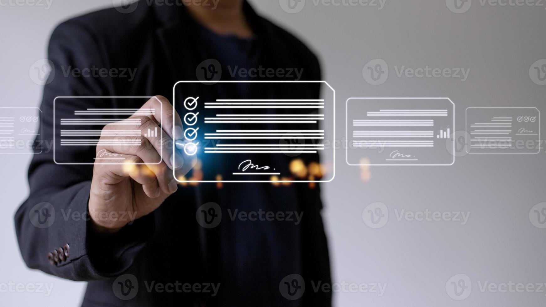 Paperless workplace ideas, e-signing, electronic signature, document management. A businessman signs an electronic document on a digital document on a virtual screen using a stylus pen. photo