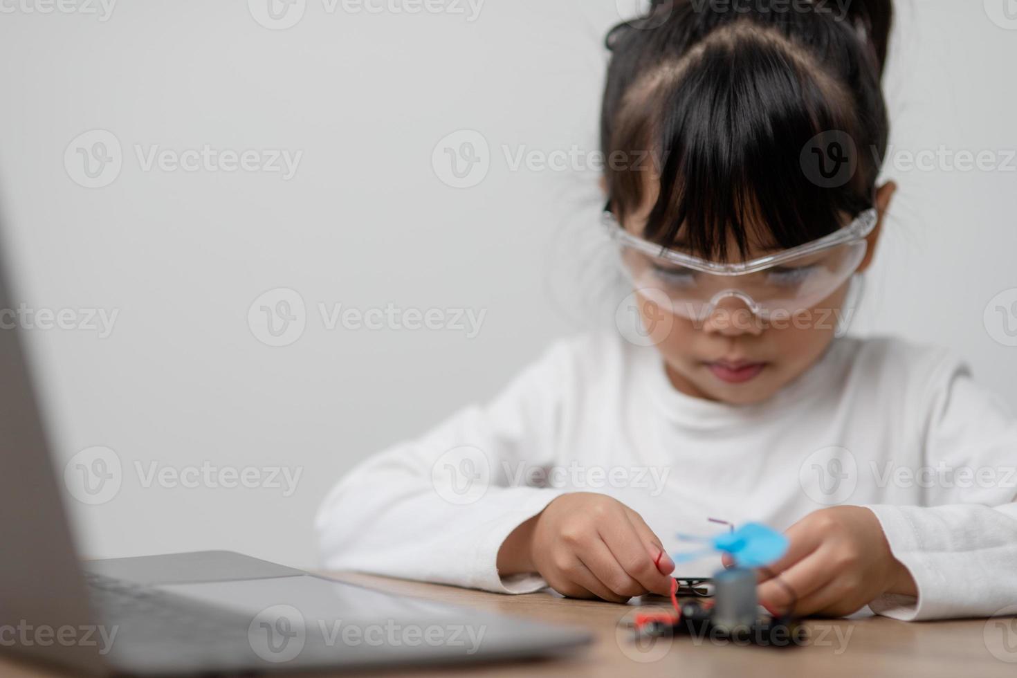 Asia students learn at home in coding robot cars and electronic board cables in STEM, STEAM, mathematics engineering science technology computer code in robotics for kids concept. photo