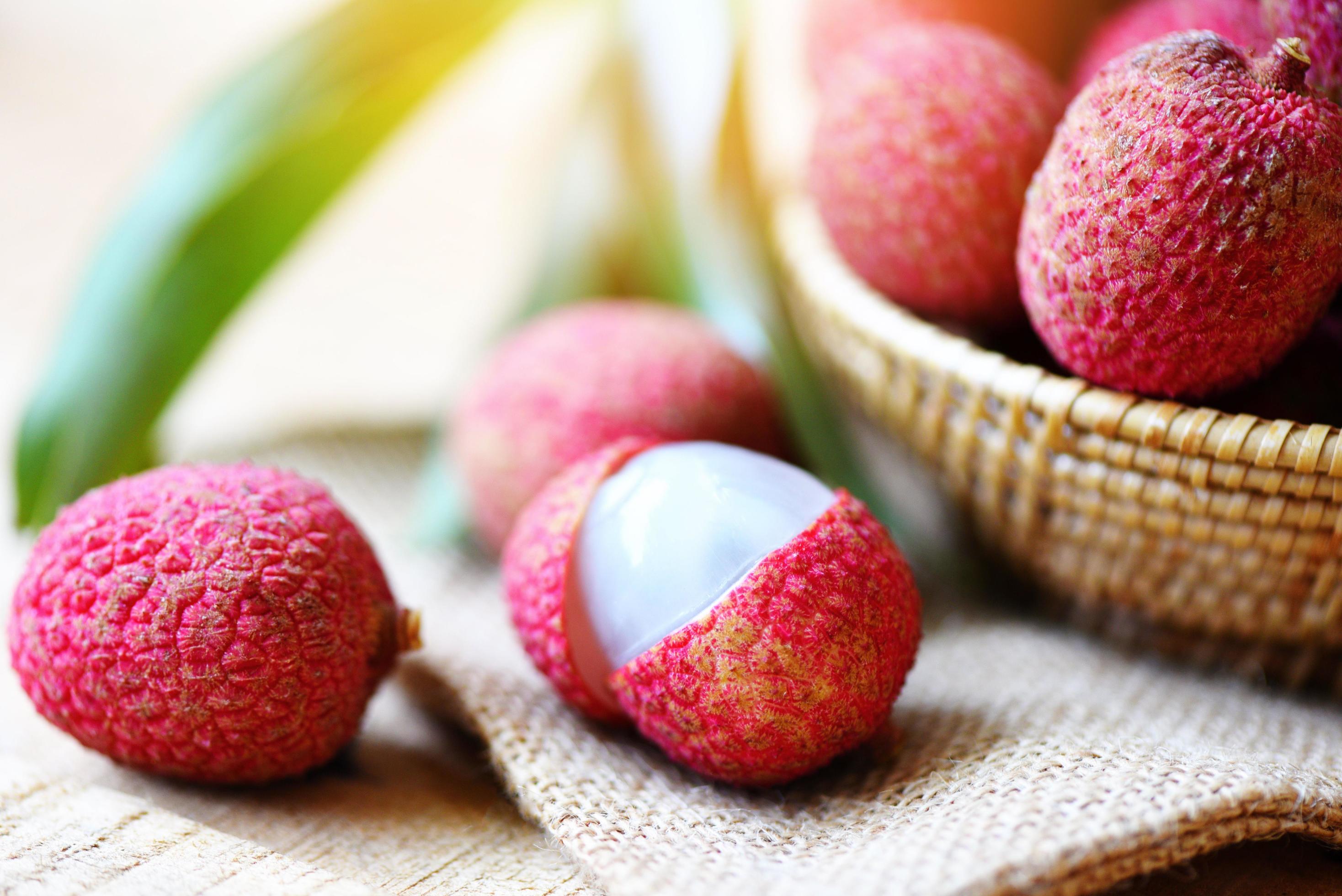 Lychee slice peeled on sack background Close up fresh lychee with