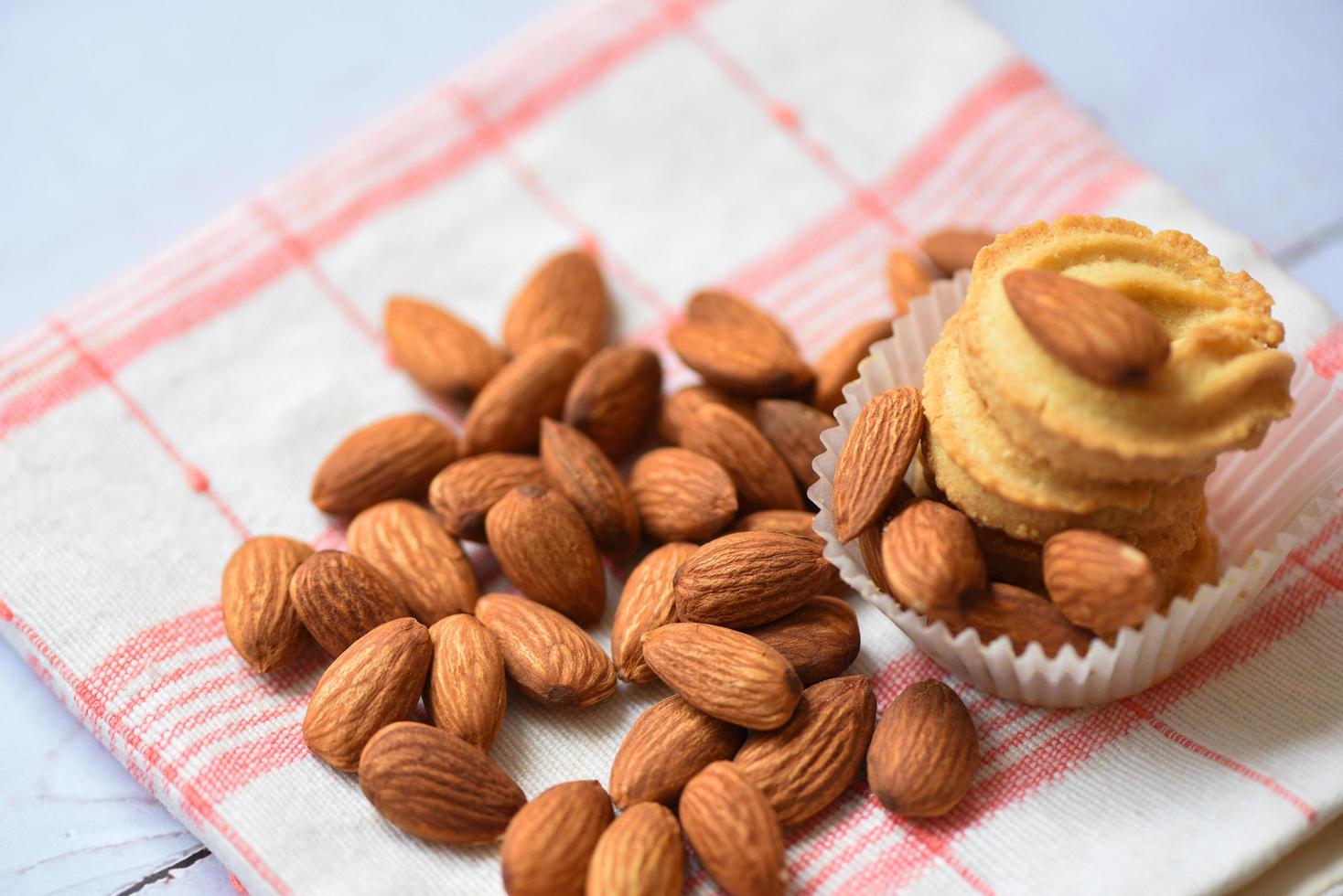 Almonds nuts on table cloths background - almond cookie for breakfast health food photo