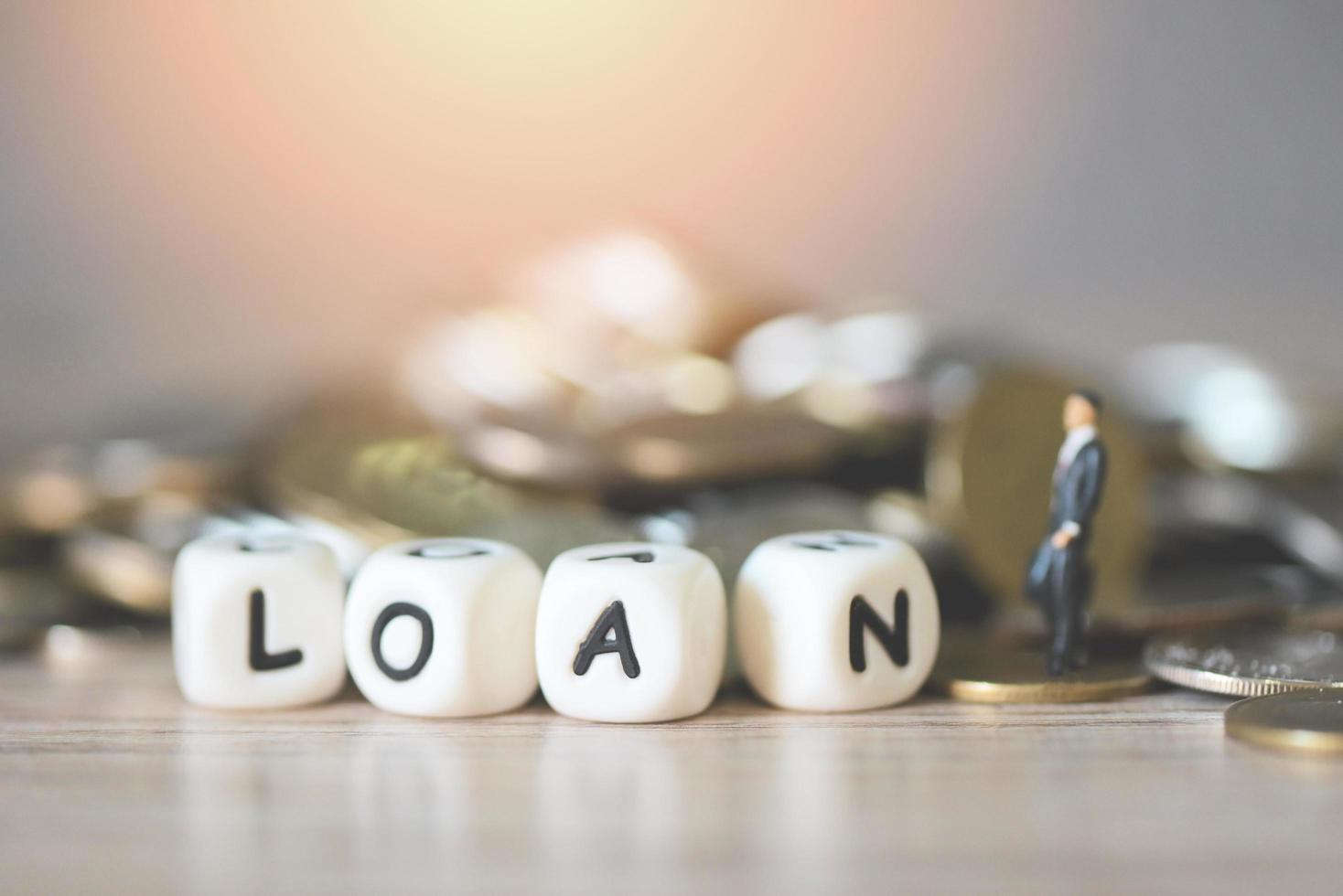 Loan business economy concept of money and finance, on table, Loan business finance economy and business man standing on a coin on wooden table background photo