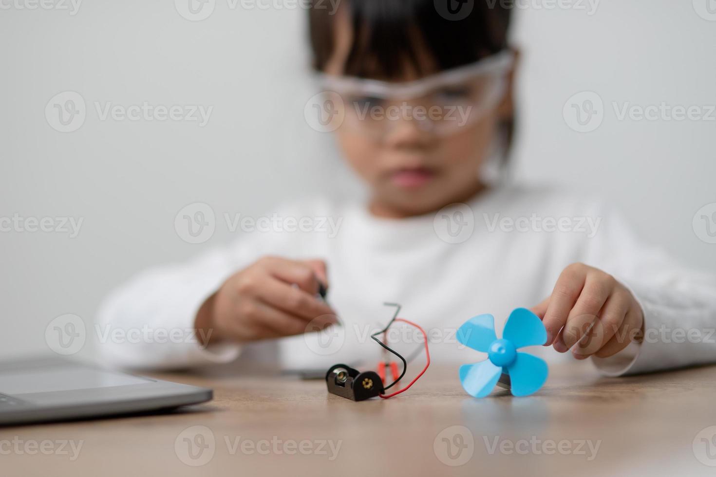 Asia students learn at home in coding robot cars and electronic board cables in STEM, STEAM, mathematics engineering science technology computer code in robotics for kids concept. photo