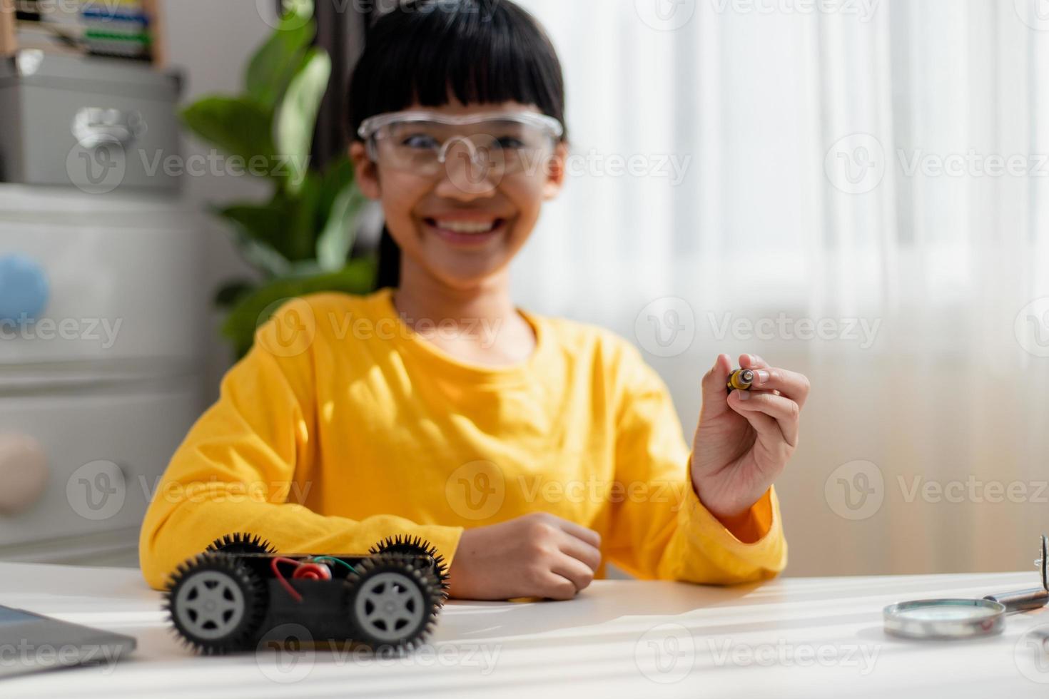 Asia students learn at home in coding robot cars and electronic board cables in STEM, STEAM, mathematics engineering science technology computer code in robotics for kids concept. photo