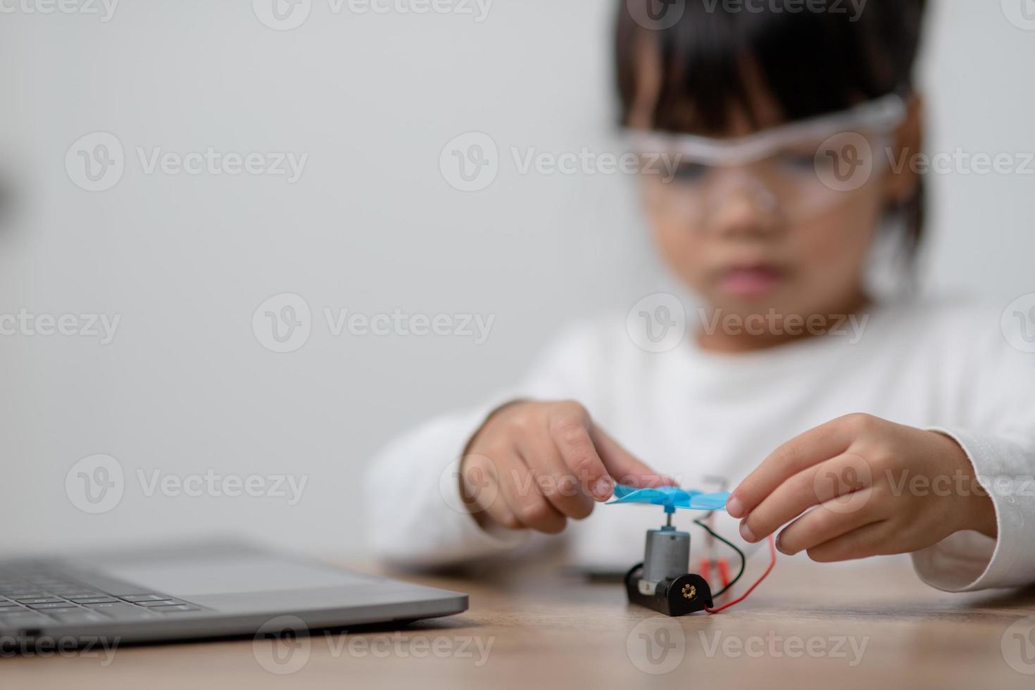 Asia students learn at home in coding robot cars and electronic board cables in STEM, STEAM, mathematics engineering science technology computer code in robotics for kids concept. photo