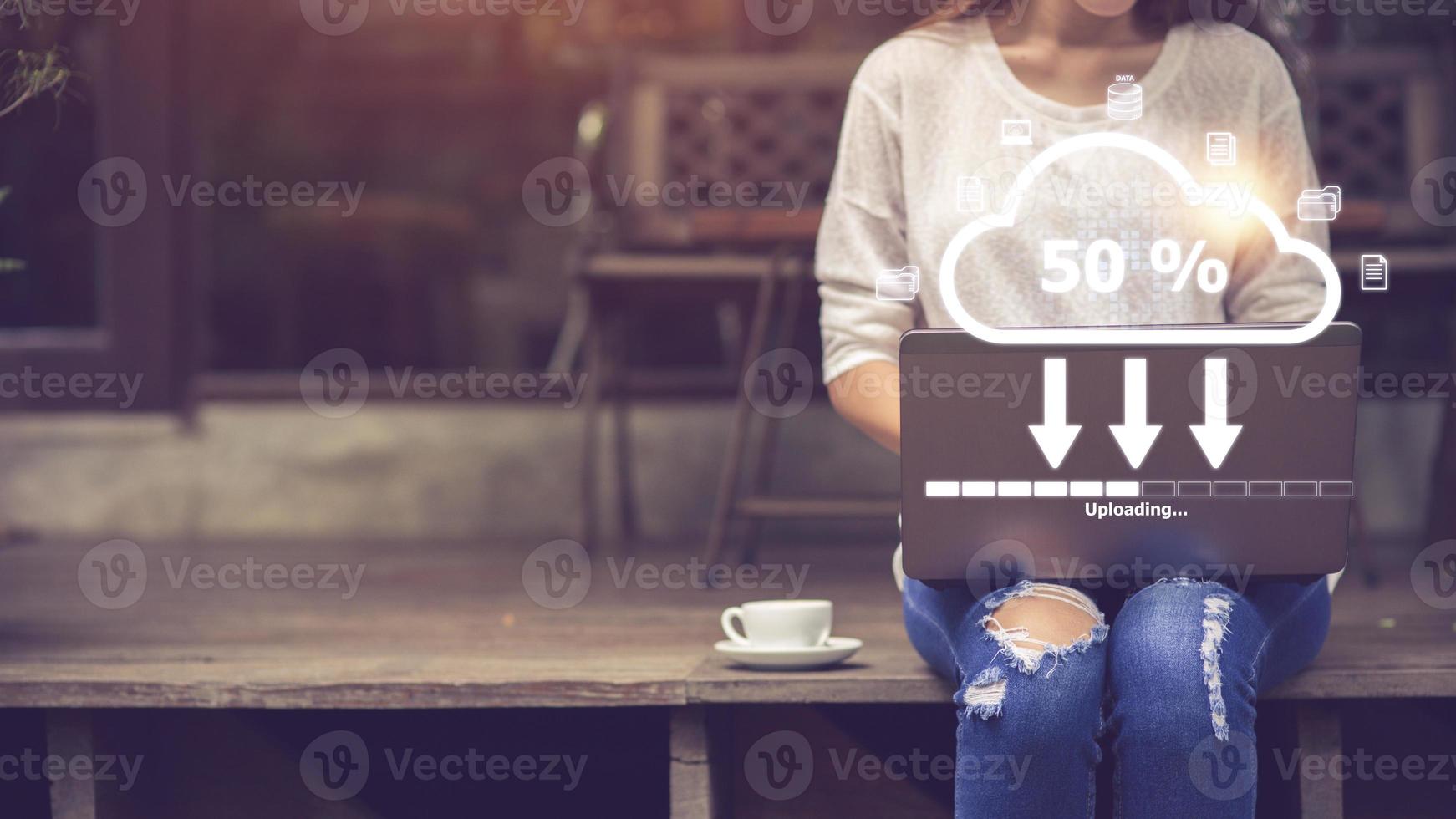 Woman doing cloud uploading on laptop in office. Data infomation photo