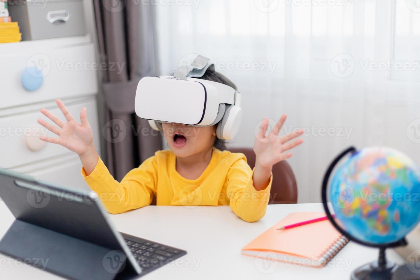 Asian Child with Virtual Reality, VR, Kid Exploring Digital Virtual World with VR Goggles. photo