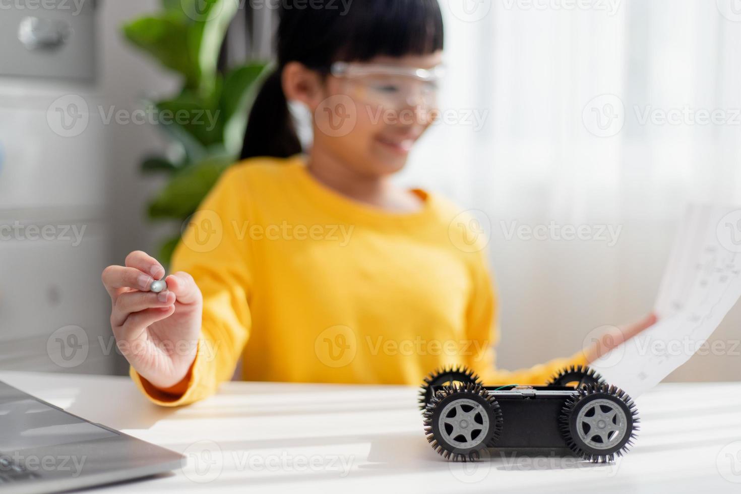 Asia students learn at home in coding robot cars and electronic board cables in STEM, STEAM, mathematics engineering science technology computer code in robotics for kids concept. photo