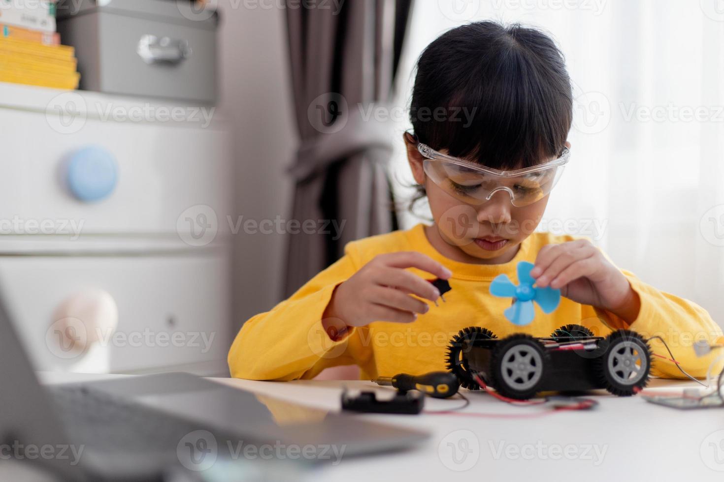 Asia students learn at home in coding robot cars and electronic board cables in STEM, STEAM, mathematics engineering science technology computer code in robotics for kids concept. photo