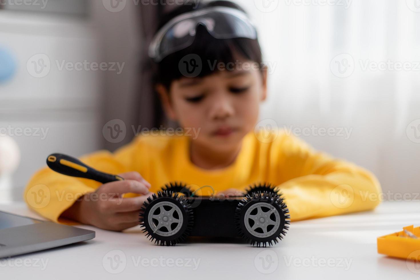 Asia students learn at home in coding robot cars and electronic board cables in STEM, STEAM, mathematics engineering science technology computer code in robotics for kids concept. photo