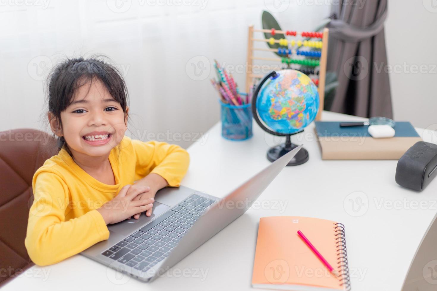 Asian little girl at home doing homework photo