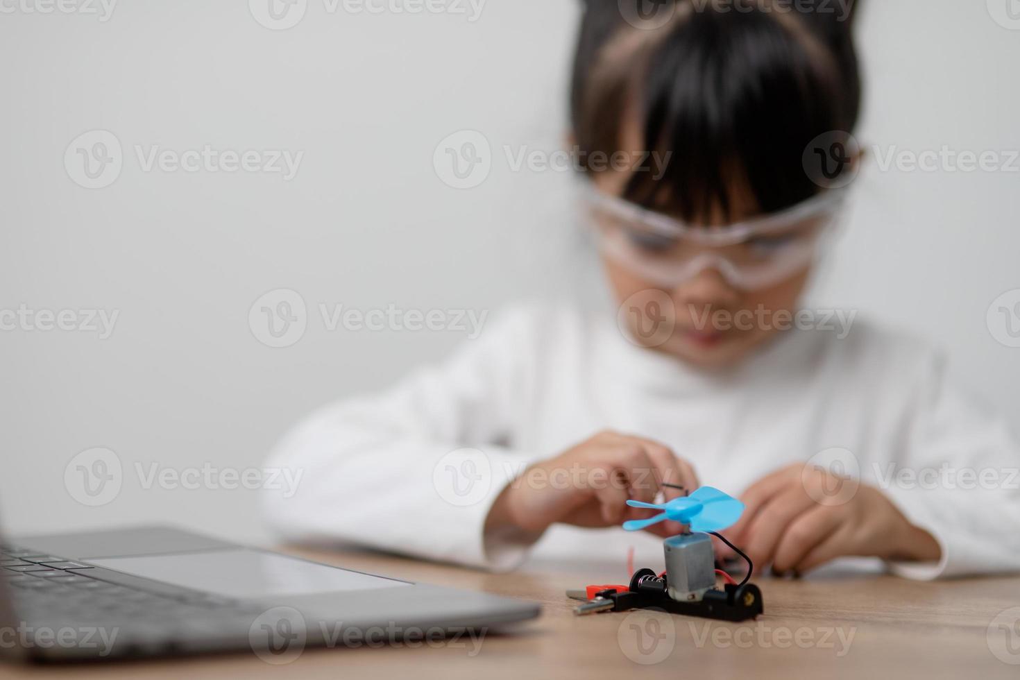 Asia students learn at home in coding robot cars and electronic board cables in STEM, STEAM, mathematics engineering science technology computer code in robotics for kids concept. photo