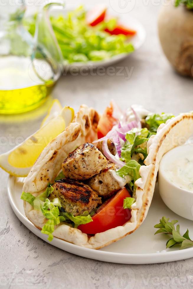 Greek chicken souvlaki on wooden skewers photo