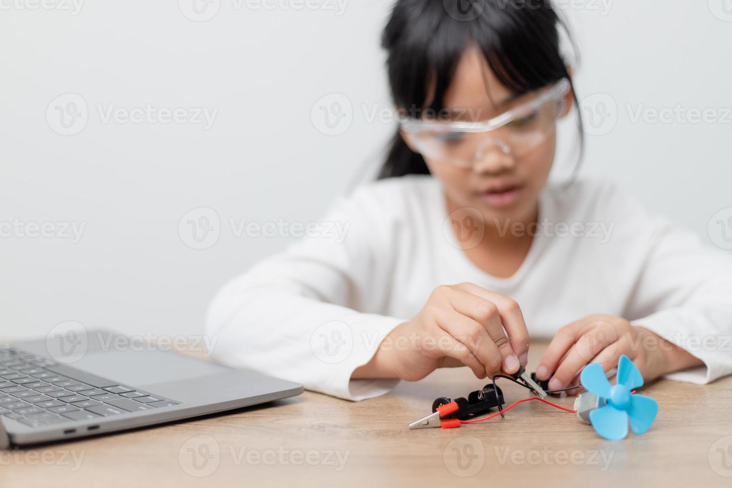 Asia students learn at home in coding robot cars and electronic board cables in STEM, STEAM, mathematics engineering science technology computer code in robotics for kids concept. photo