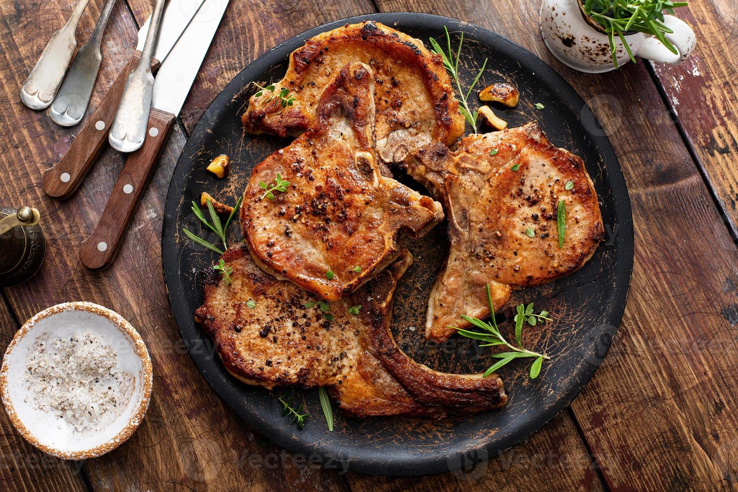 Grilled or pan fried pork chops on the bone photo