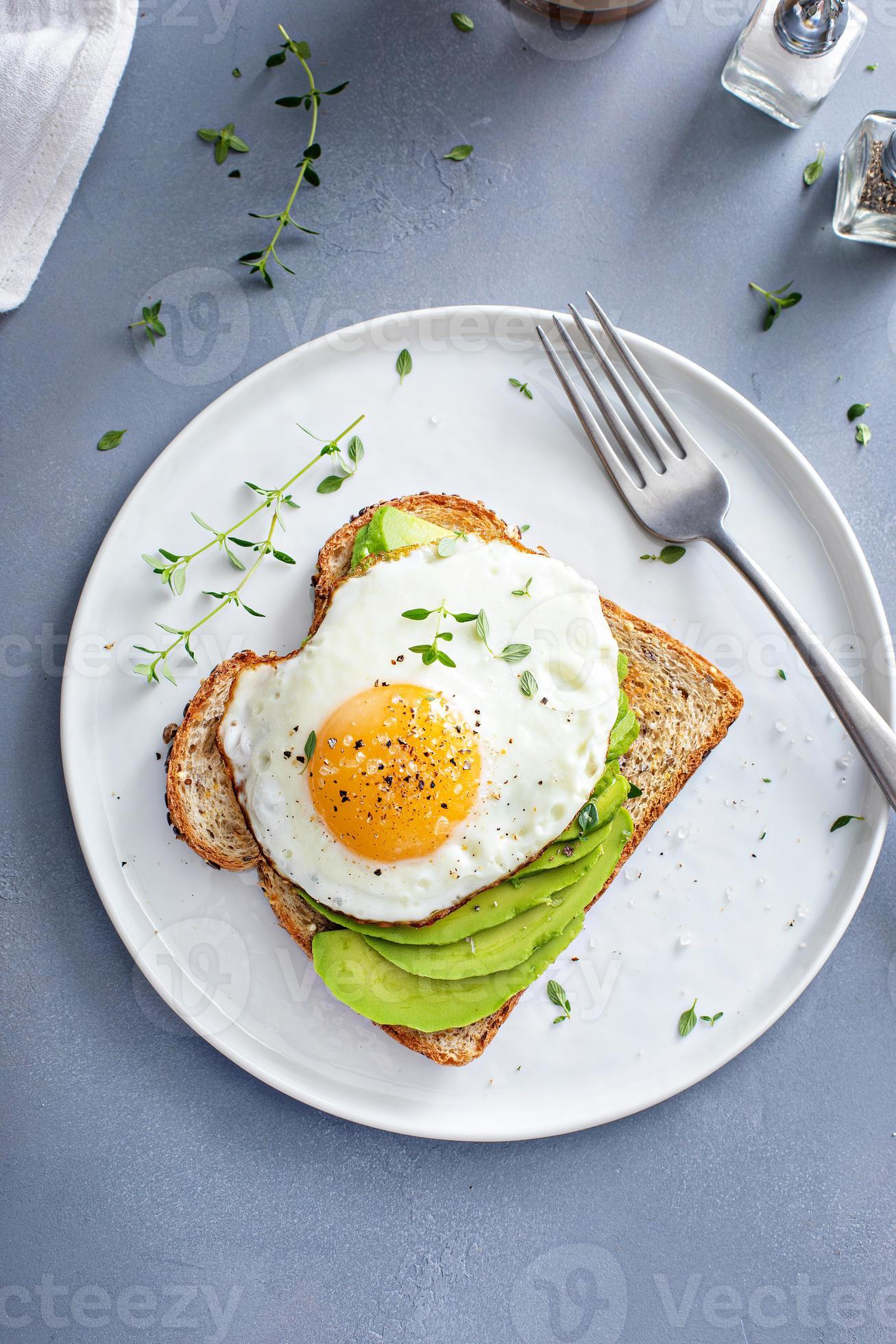 Avocado toast on a toasted multigrain bread with a fried egg 15944592