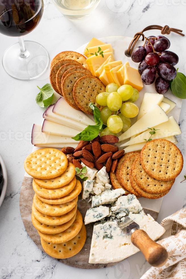 Cheese board with crackers, nuts and grapes photo