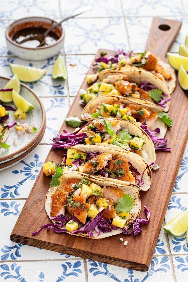 Fish tacos with mango salsa and red cabbage photo